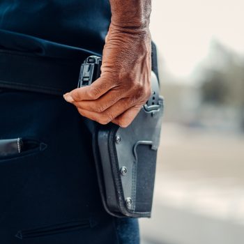 Person Holding a Gun in a Holster